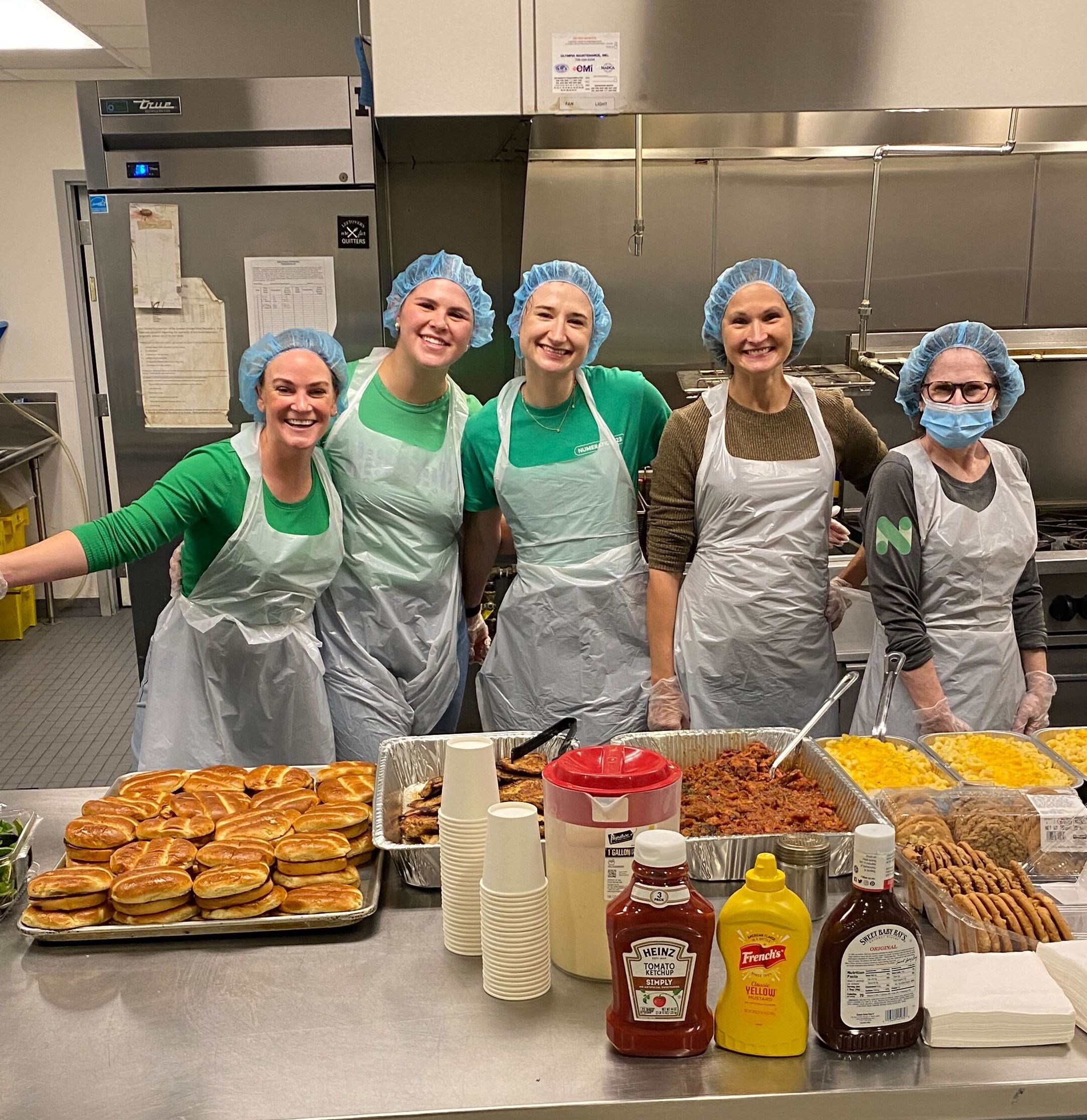 Numerator employees volunteering serving lunch at a shelter