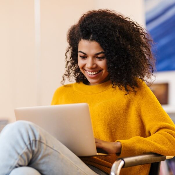 woman smiling at laptop