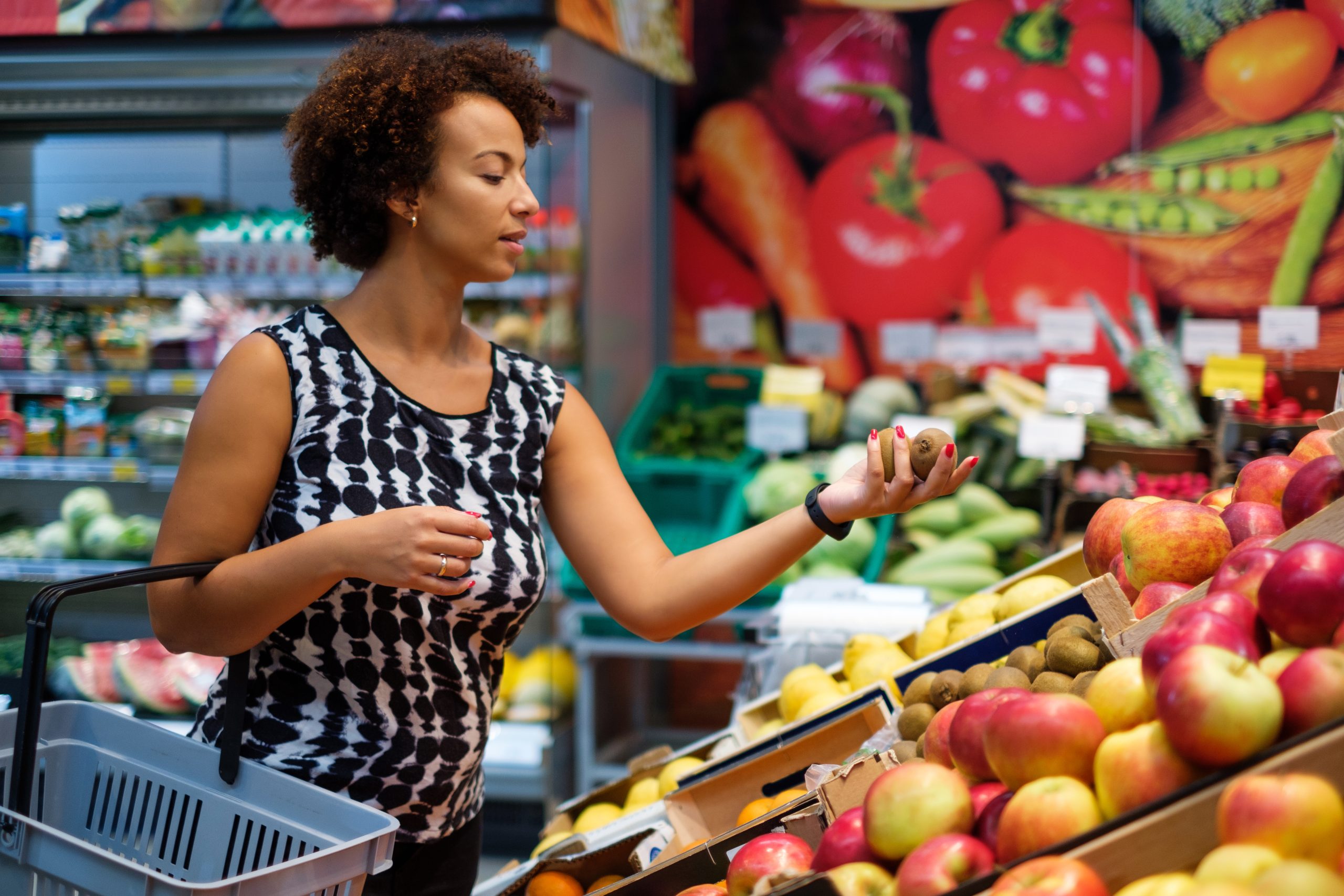Woman looking at produce at grocery store