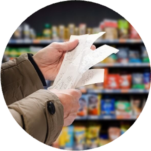 man holding shopping receipts in a grocery store