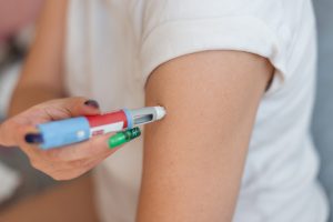 a person giving themselves a glp-1 shot
